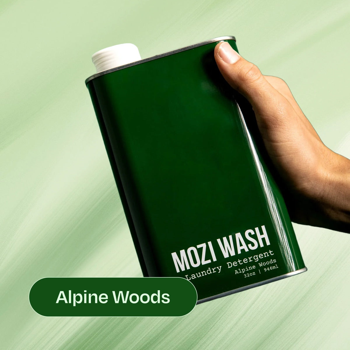 Alpine Woods Mozi Wash laundry detergent bottle held in hand