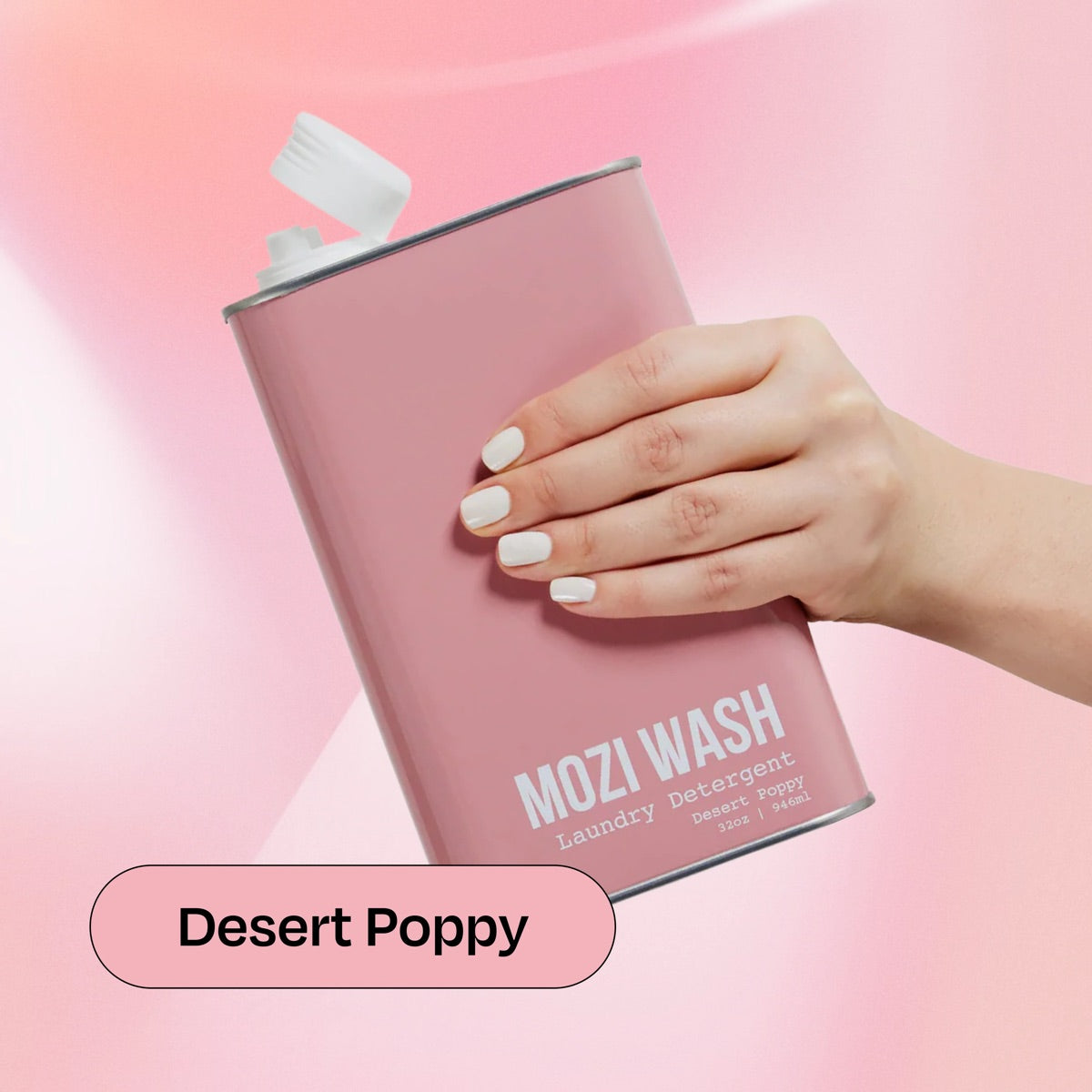 Desert Poppy Mozi Wash laundry detergent bottle held in hand