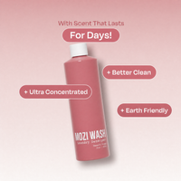A pink bottle of Mozi Wash laundry detergent with a white cap, shown on a soft pink gradient background with promotional text callouts.