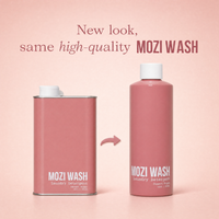 Two MOZI WASH laundry detergent containers on a soft pink background, with text reading 'New look, same high-quality MOZI WASH' above them. One container is a rectangular canister and the other is a rounded bottle, both in dusty pink with white caps and white printed branding.